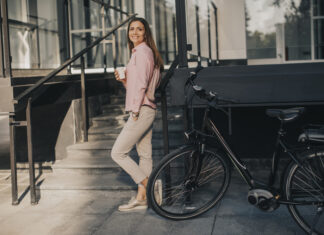 Hoe kies je de beste elektrische fiets? vrouw met koffie bij elektrische fiets